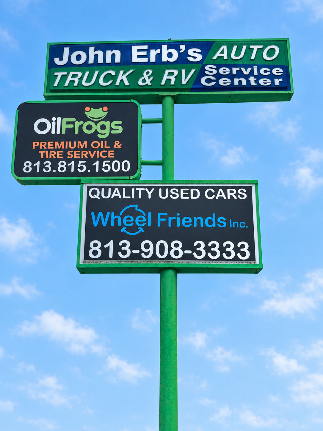 Roadside sign for John Erb’s Service Center, Oil Frogs and Wheel Friends